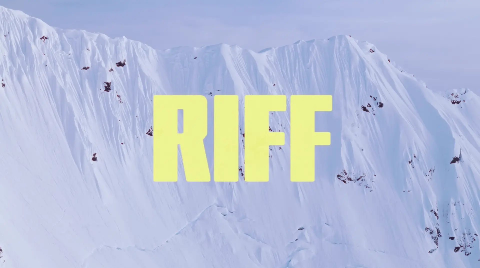 RIFF film title card, bold yellow letters over an aerial snow-covered spine wall
